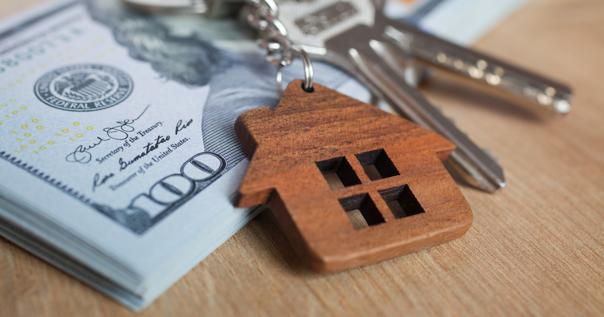 American 100 dollar, cash or housing. House keys close-up