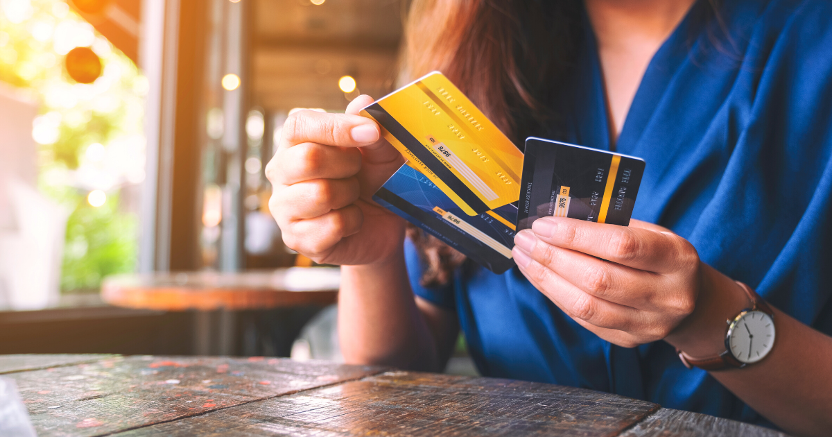 a woman holding and choosing credit card to use