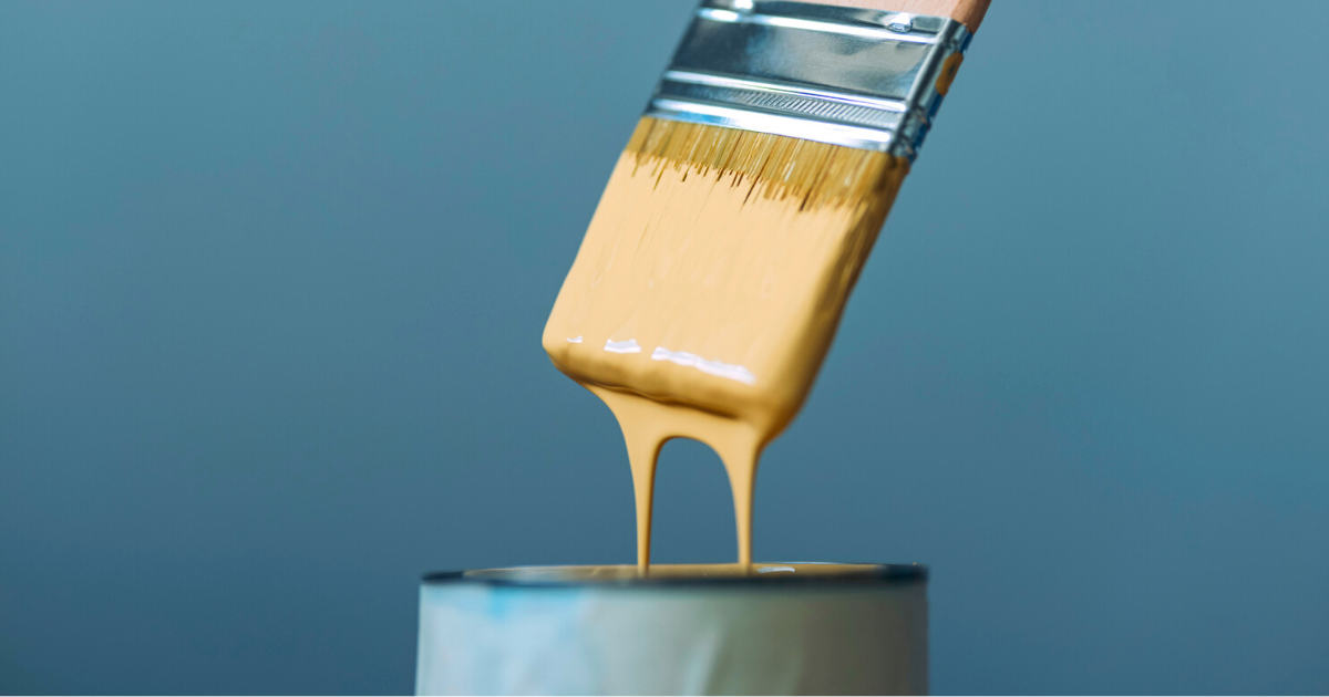 Close Up Of Woman Dipping The Brush Into The Yellow Paint