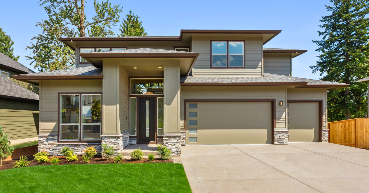 Beautiful suburban home exterior on bright sunny day with green grass and blue sky