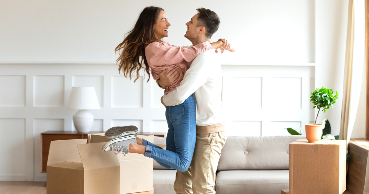 Overjoyed couple dancing excite to move in together