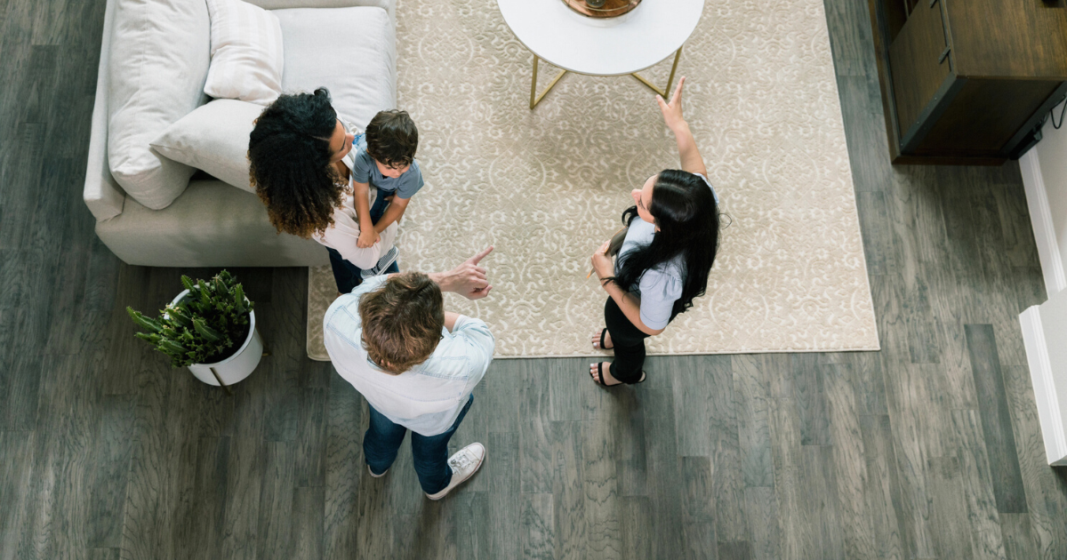 High angle view real estate agent showing house to family