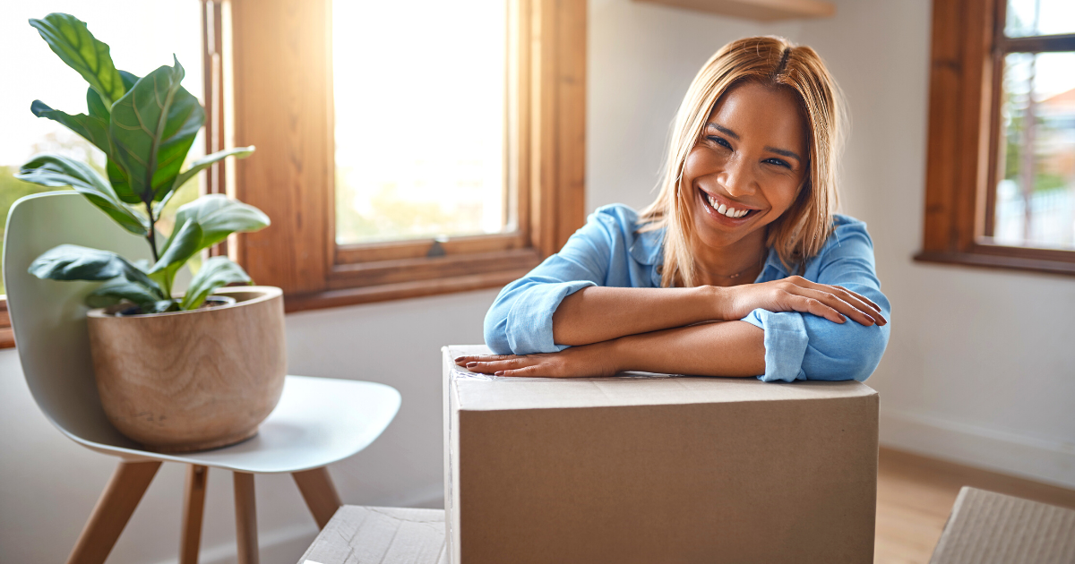 smiling woman moving into her new house