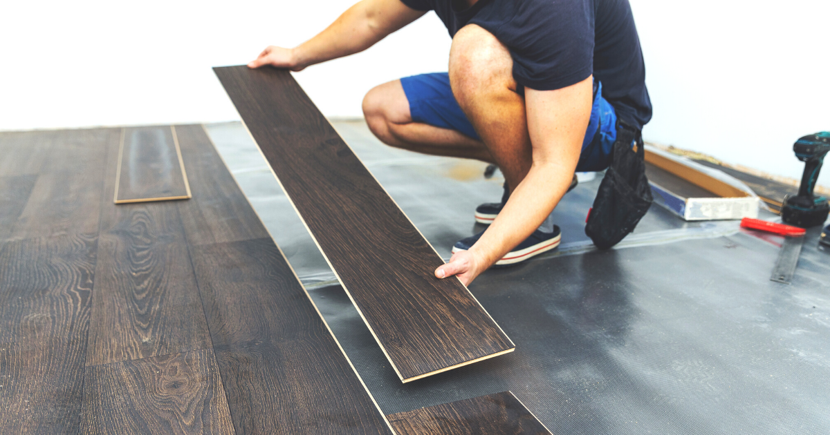 laminate flooring - worker installing new floor