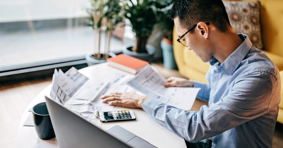 man calculating financial bills at home