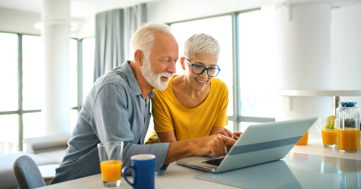 Mature couple learning about reverse mortgages on their computer