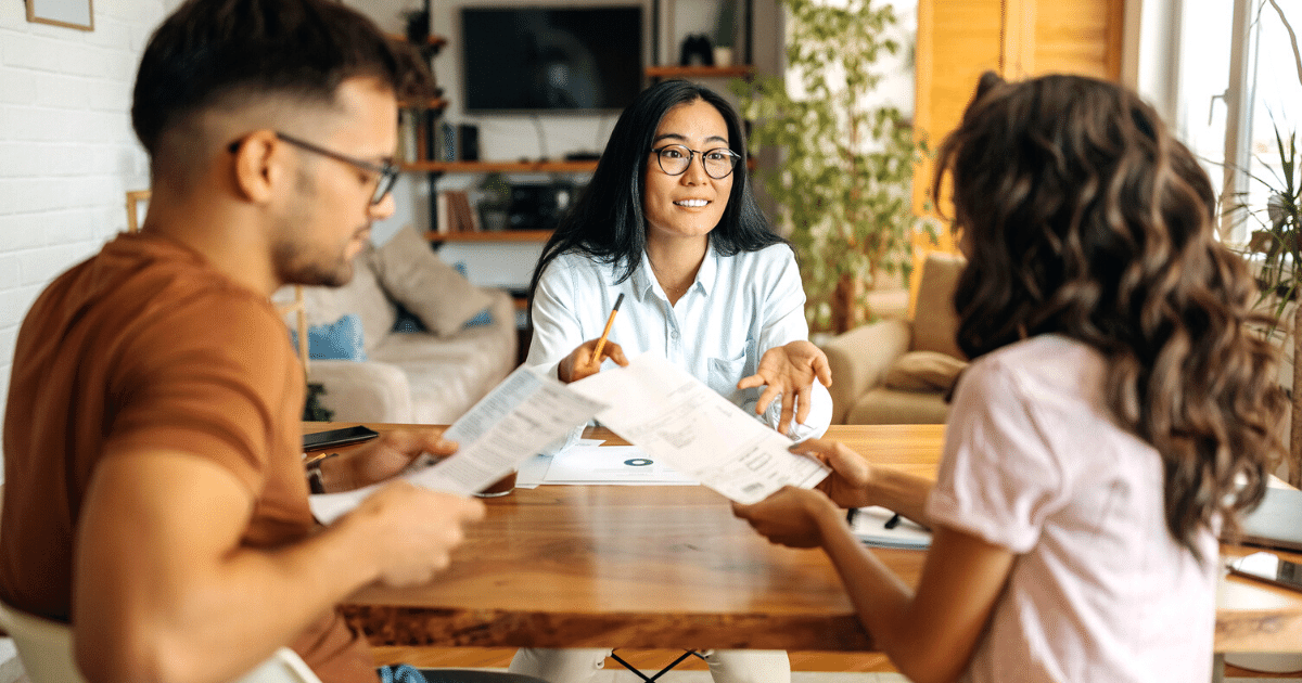 Young mortgage consultant helping couple with their home financing