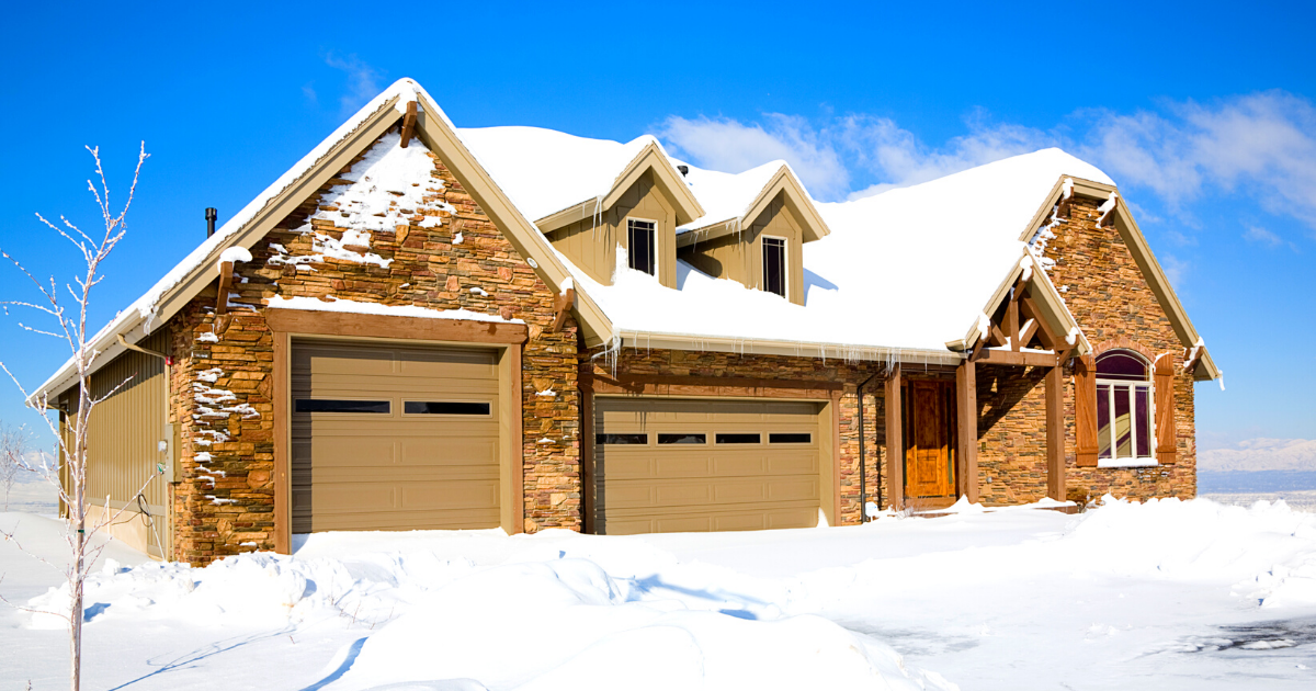 A snow covered home under clear blue sky