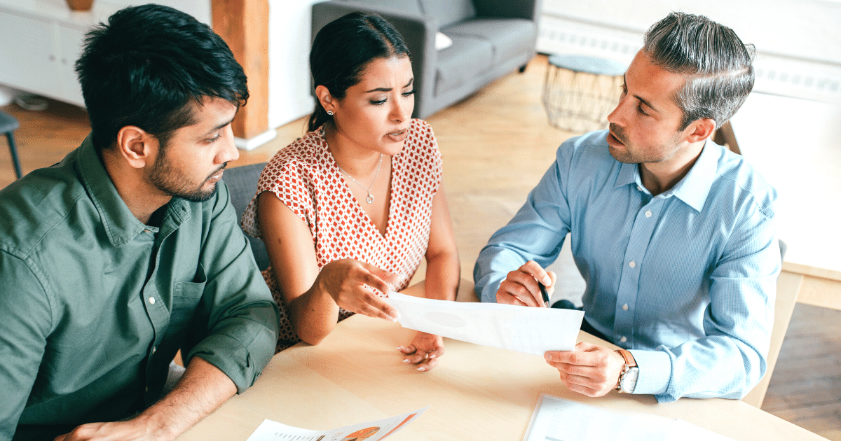 Real Estate Agent discussing a Seller Paid Buydown with a couple at the kitchen table