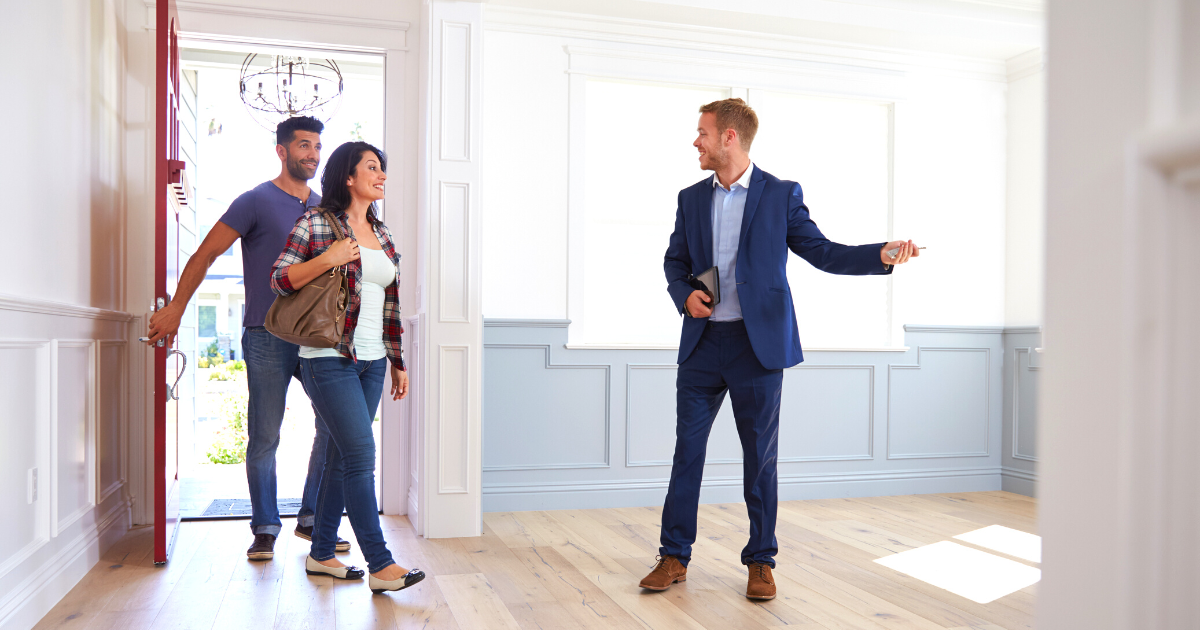 Realtor showing couple around new home