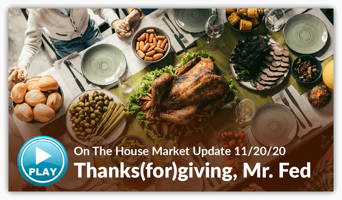 People gathered around a thanksgiving feast with a play button in the corner
