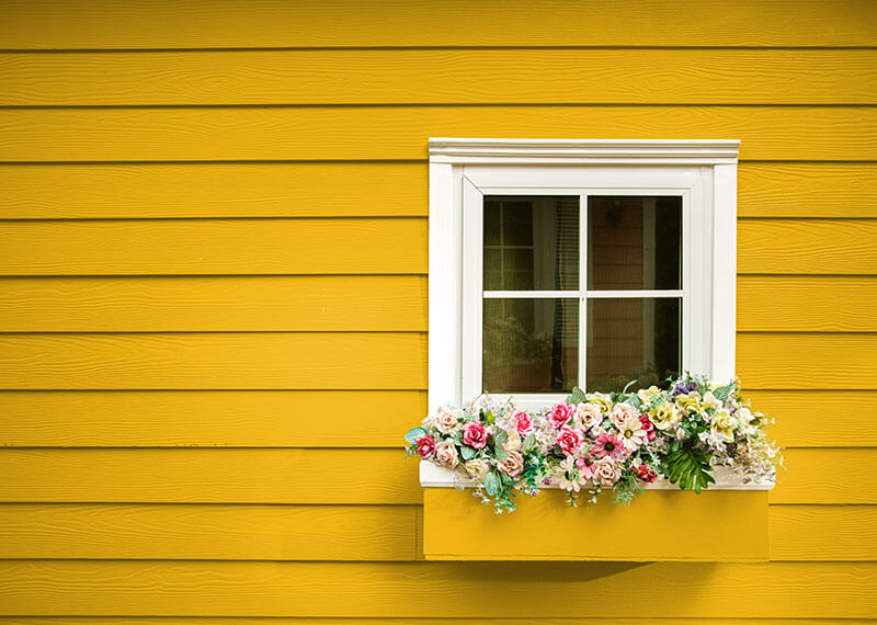 FHA Streamline Refinance at PRMI Yellow house with flower box