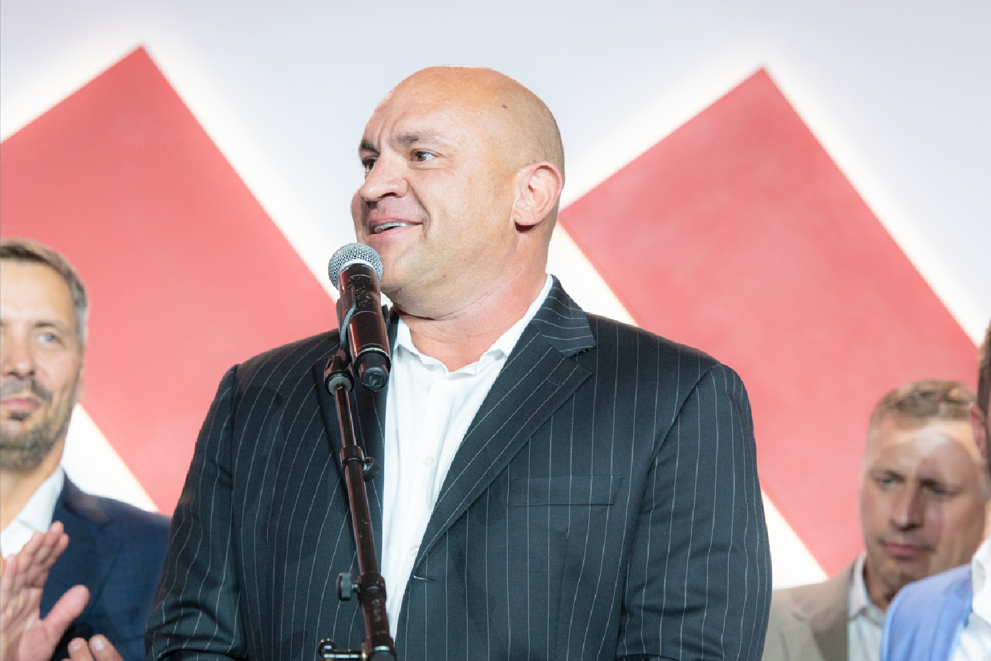 Geoff Rooker accepting an award surrounded by people