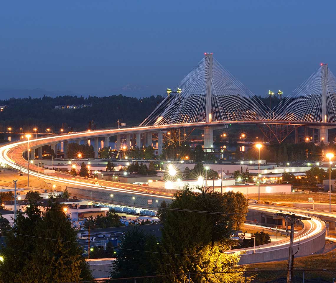 A bridge at night with Mount Rainer in the background