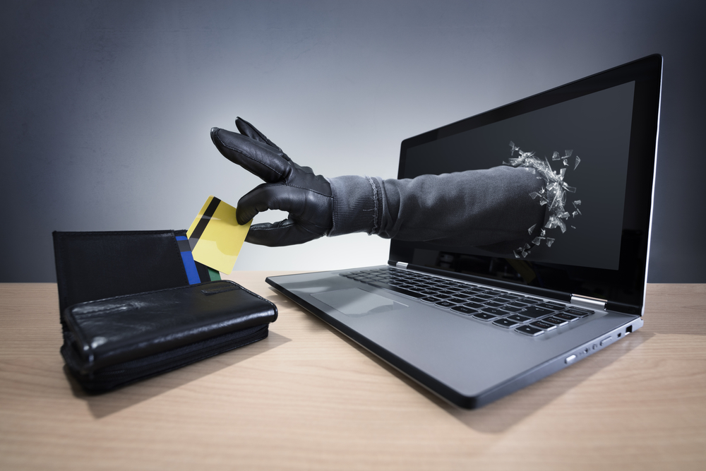 Arm coming out of a laptop and stealing money