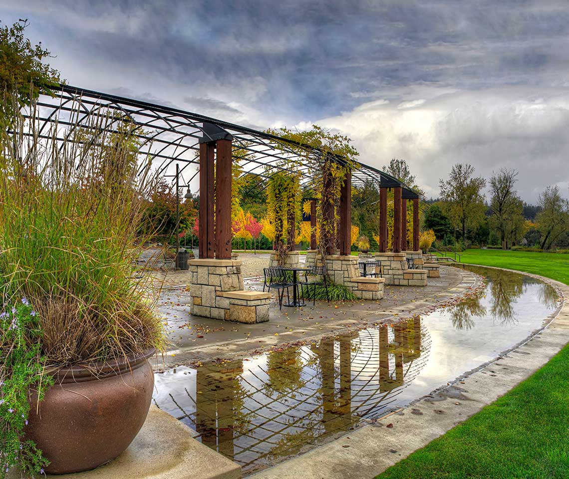 A metal overhead in a park during a rainstorm